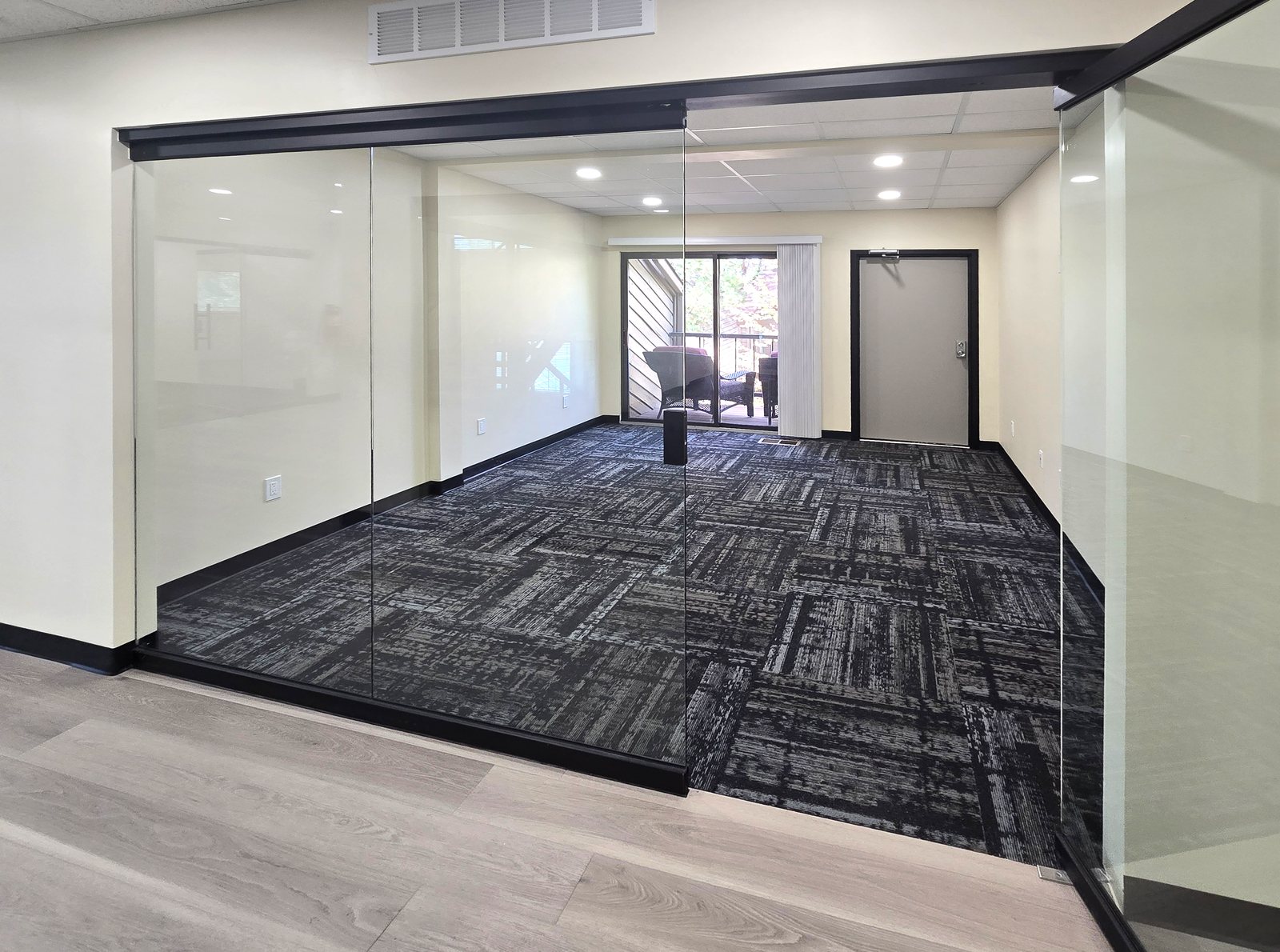 Glass-walled private office with balcony entry at ZipDesk Coworking in the Denver Tech Center